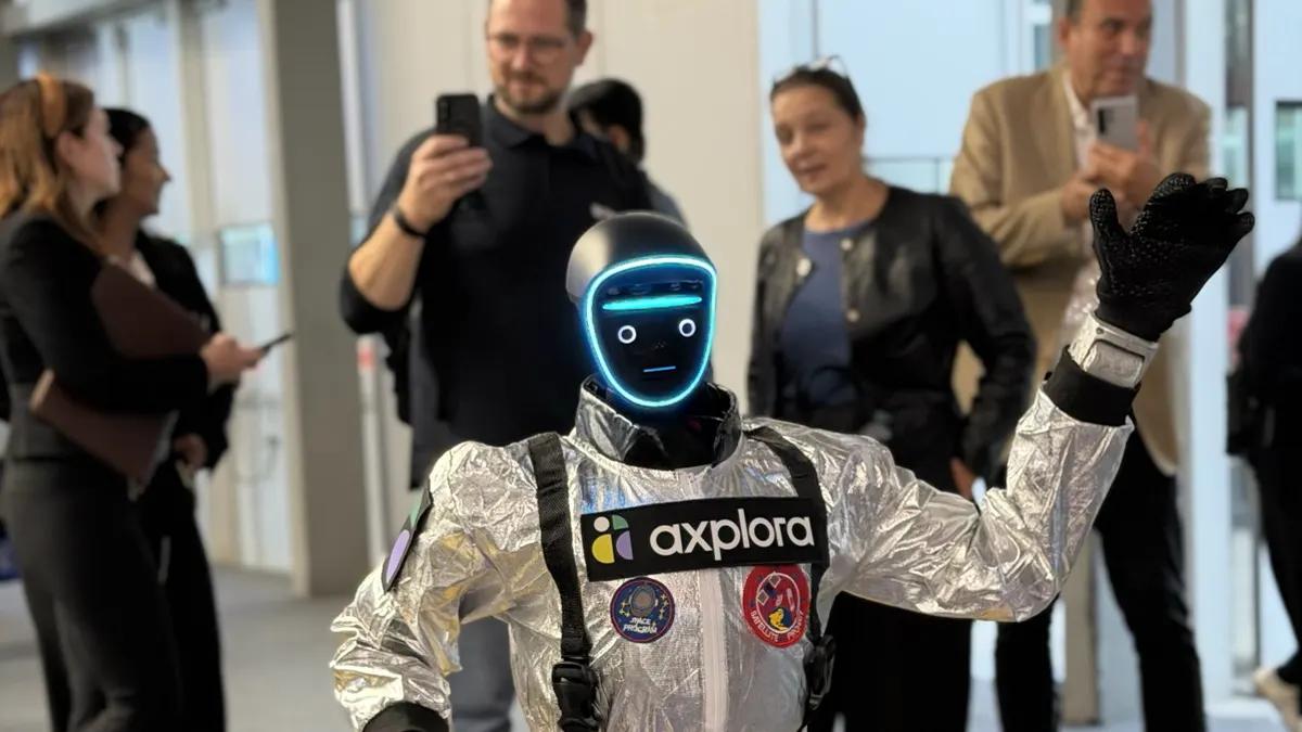 LéoBot, ein humanoider Roboter im silbernen Overall, winkt, während Besucher der CPHI Milan ihn mit dem Smartphone filmen.