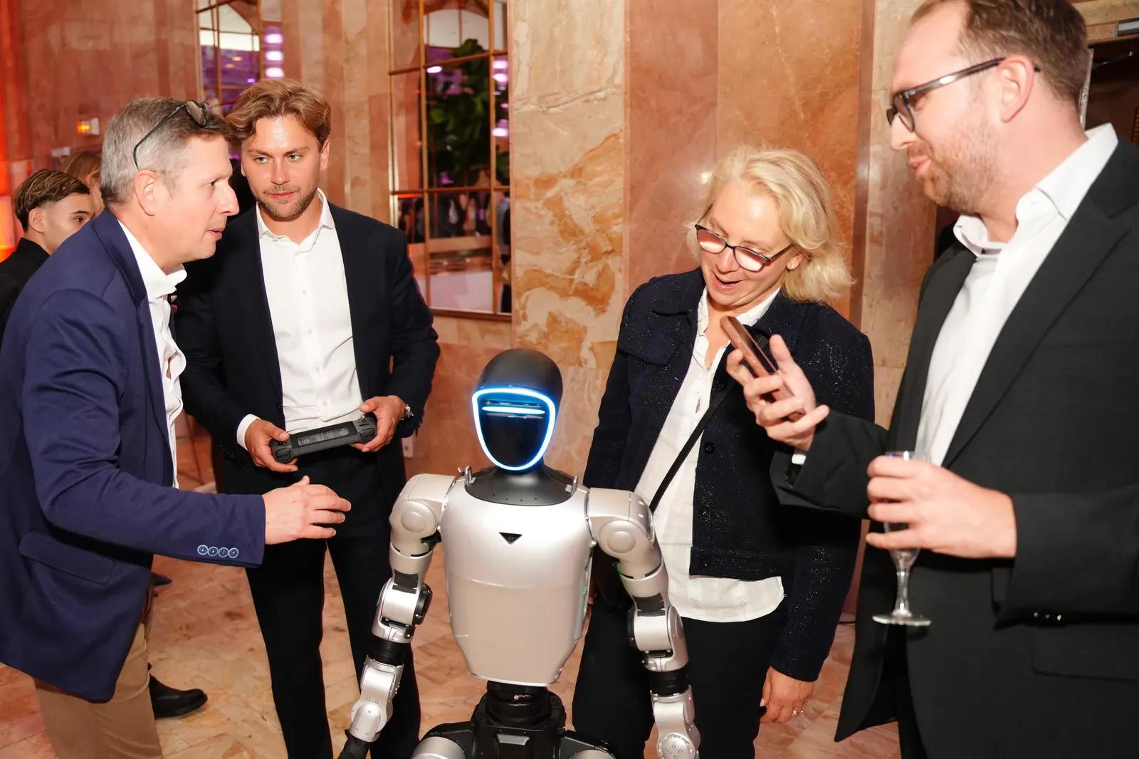 Invités d'un gala échangeant avec le robot humanoïde Unitree G1 de Libella Robotics